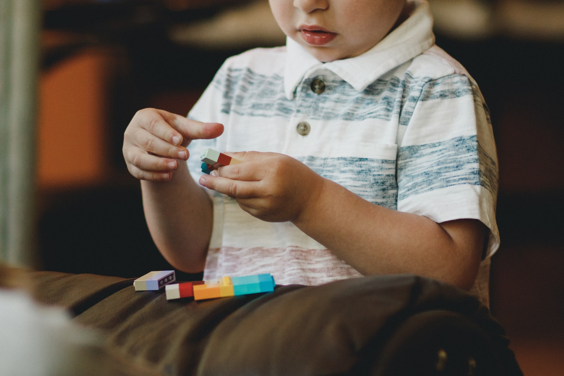 Boy with autism playing with toy blocks